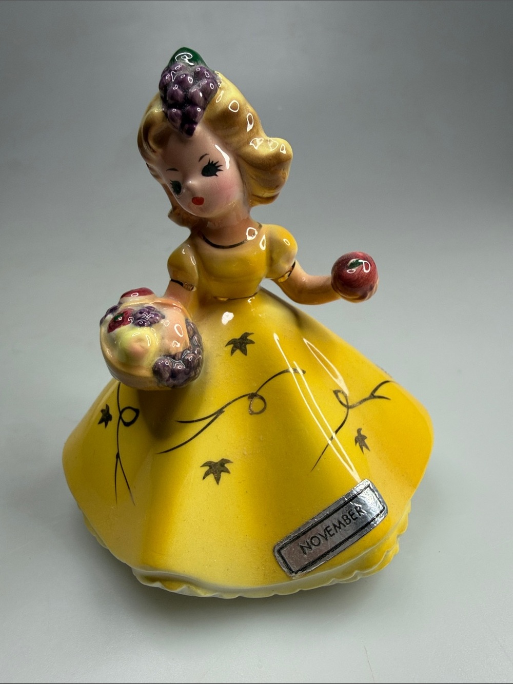 Vintage Yellow Ceramic November Figurine Girl with Fruit